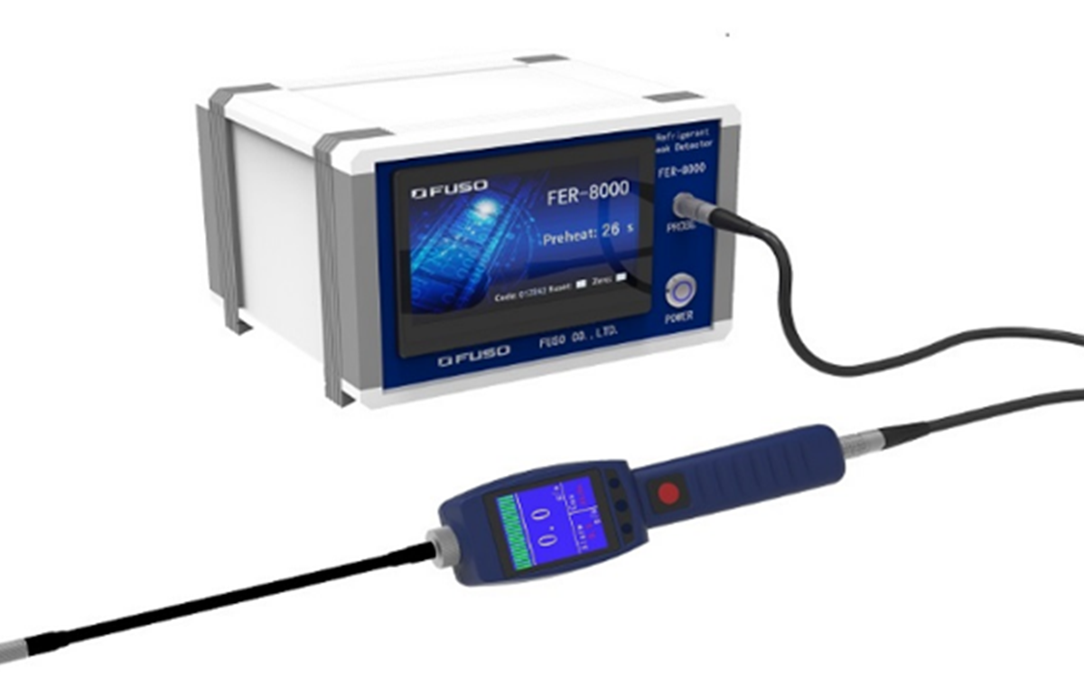 A grey piece of technology with a blue wire on a white background