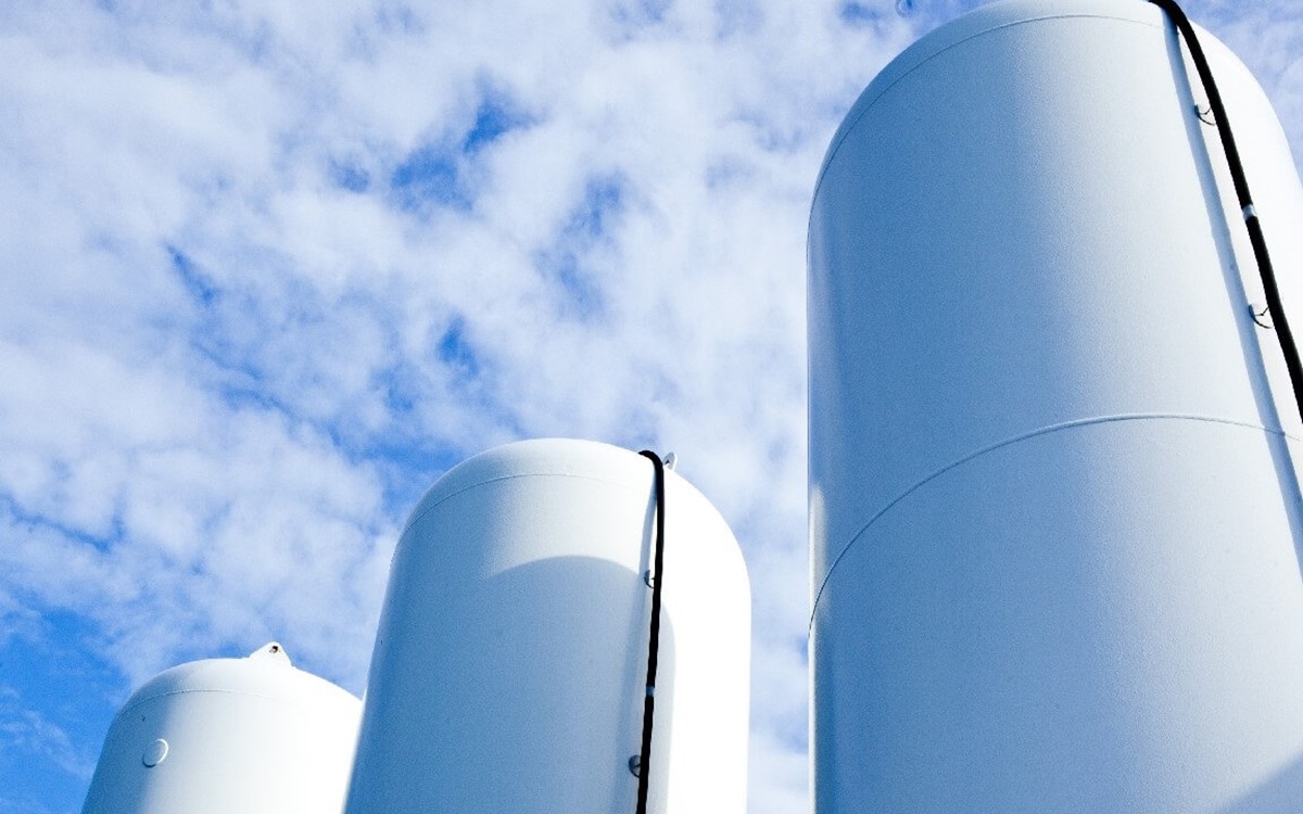 3 large industrial cylinders under blue skies