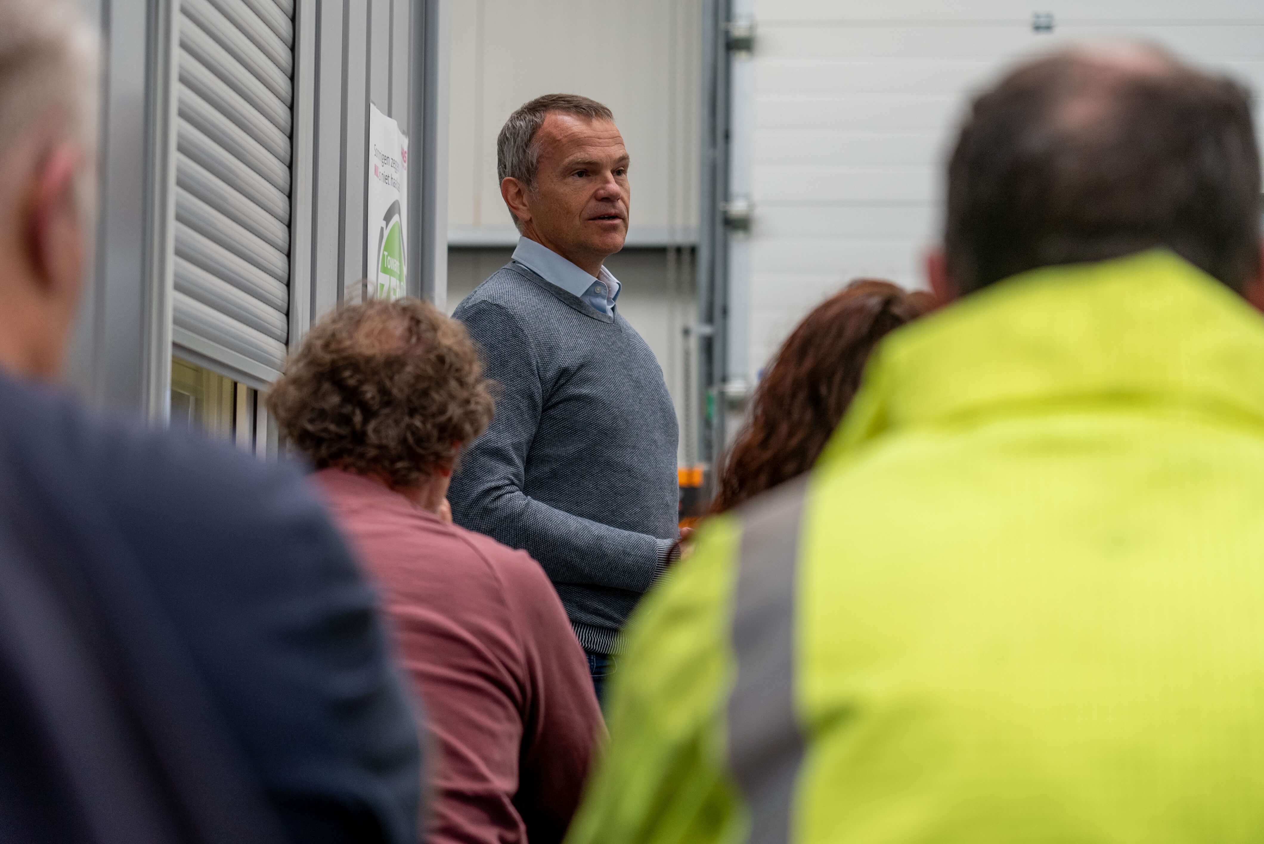 A man presenting to a crowd in an office 