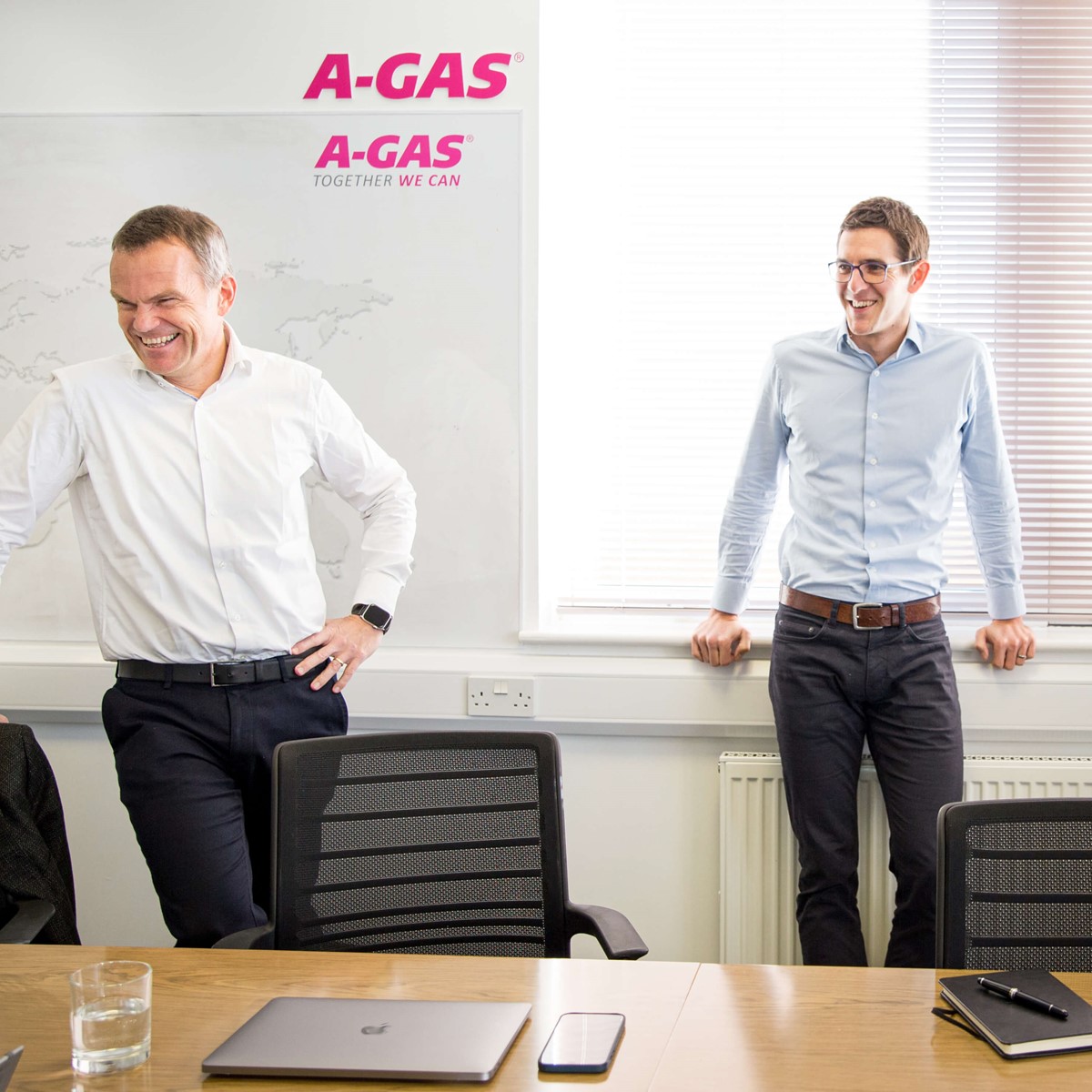 office executives laughing in a meeting