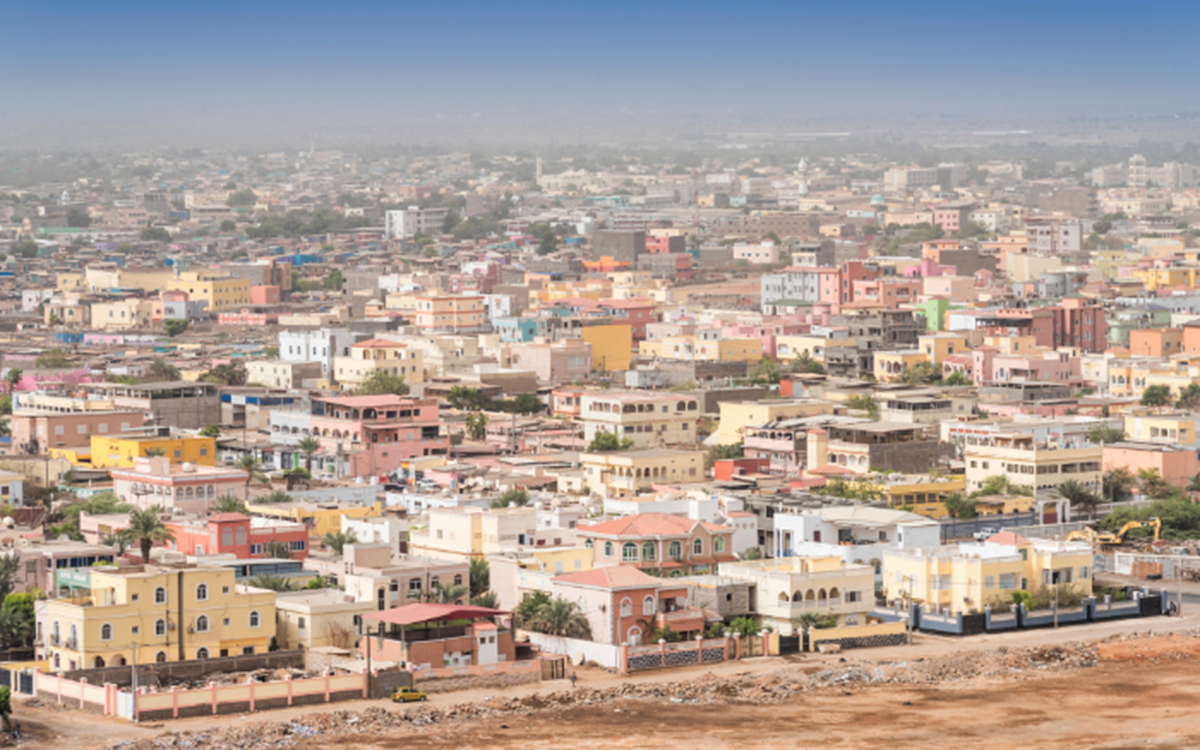 A picture of a city against the backdrop of a desert