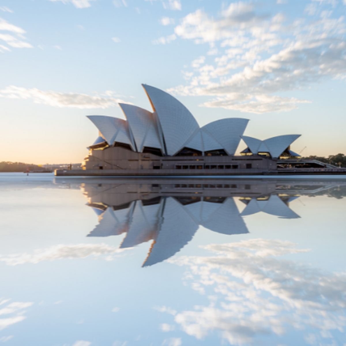A wide angle shot of the Sydney Opera House with it's reflection in the water