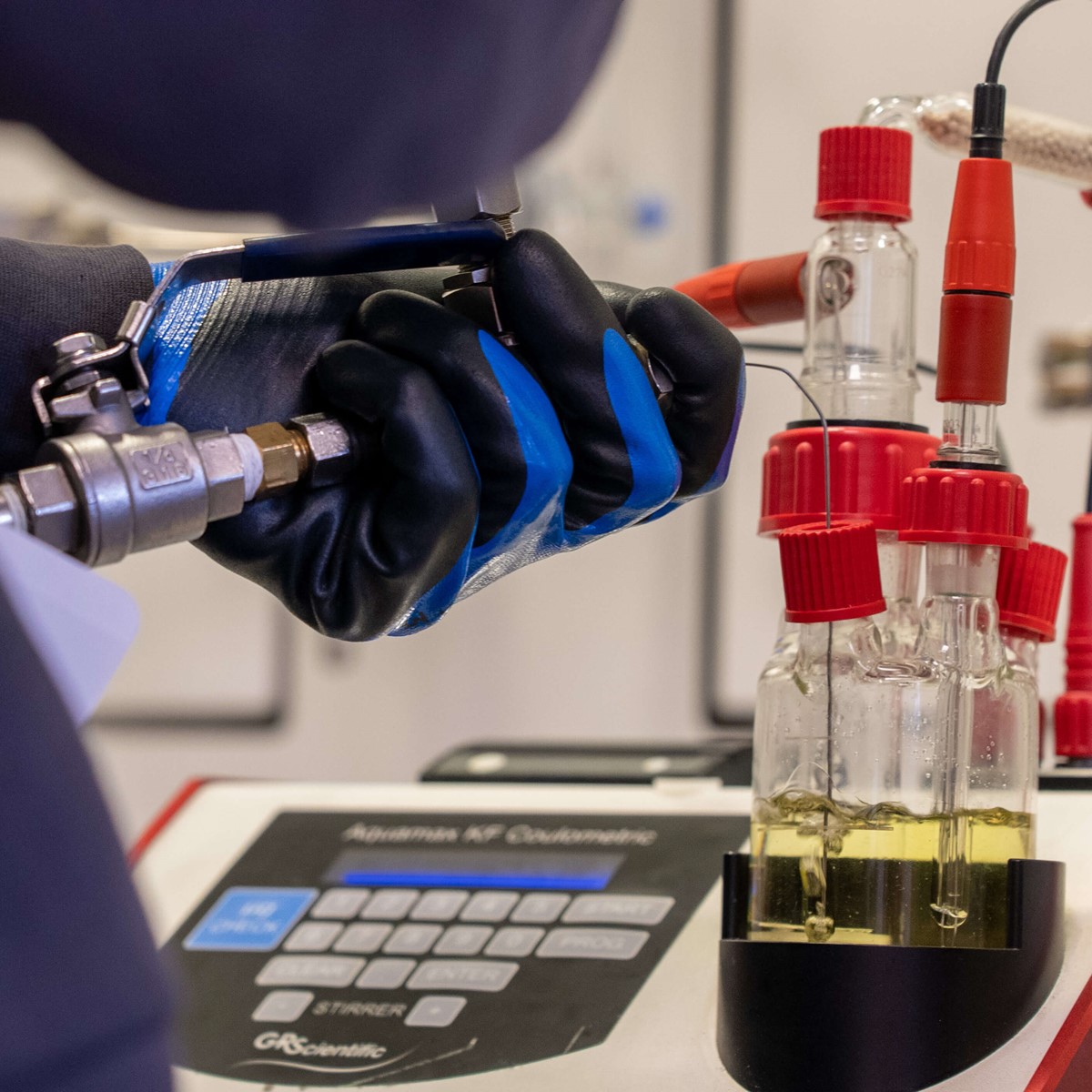 A man in protective gloves using laboratory equipment