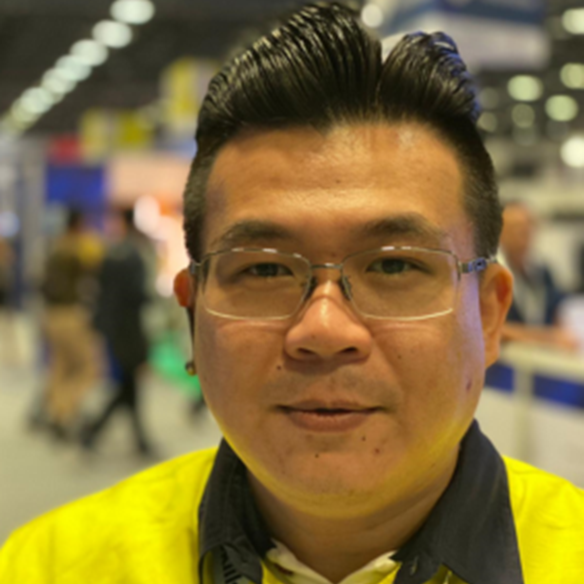Headshot of a man against a blurred environment