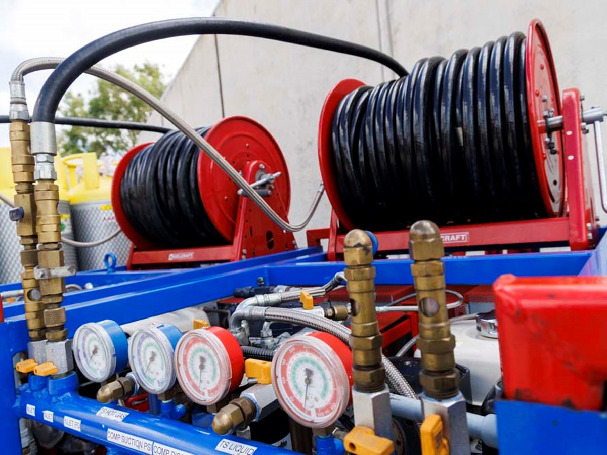 Rolls of black wire on top of blue recovery equipment