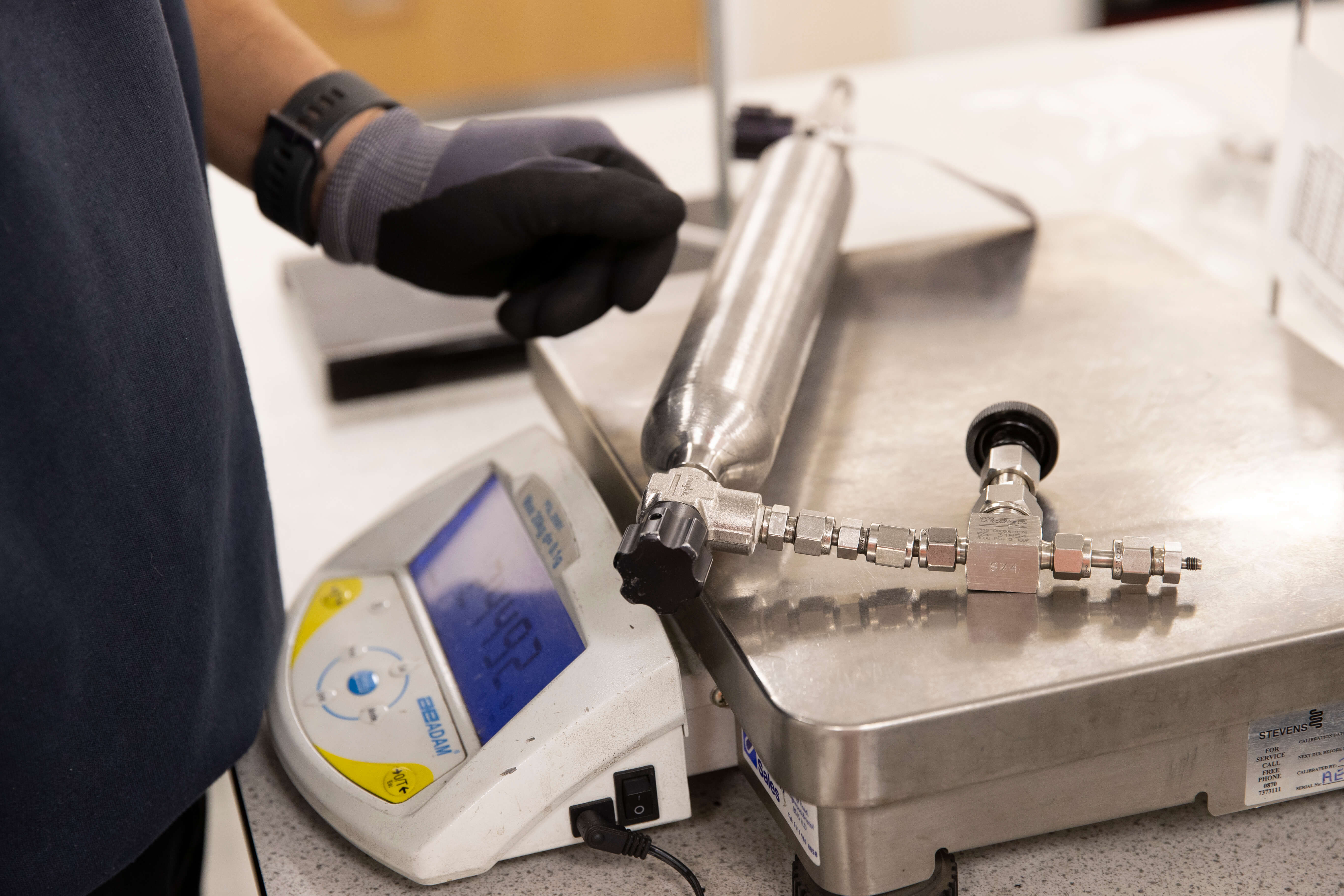 lab technician preparing cylinder analysis checks