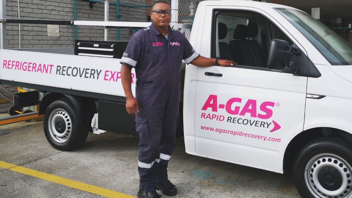 A man standing next to a white truck