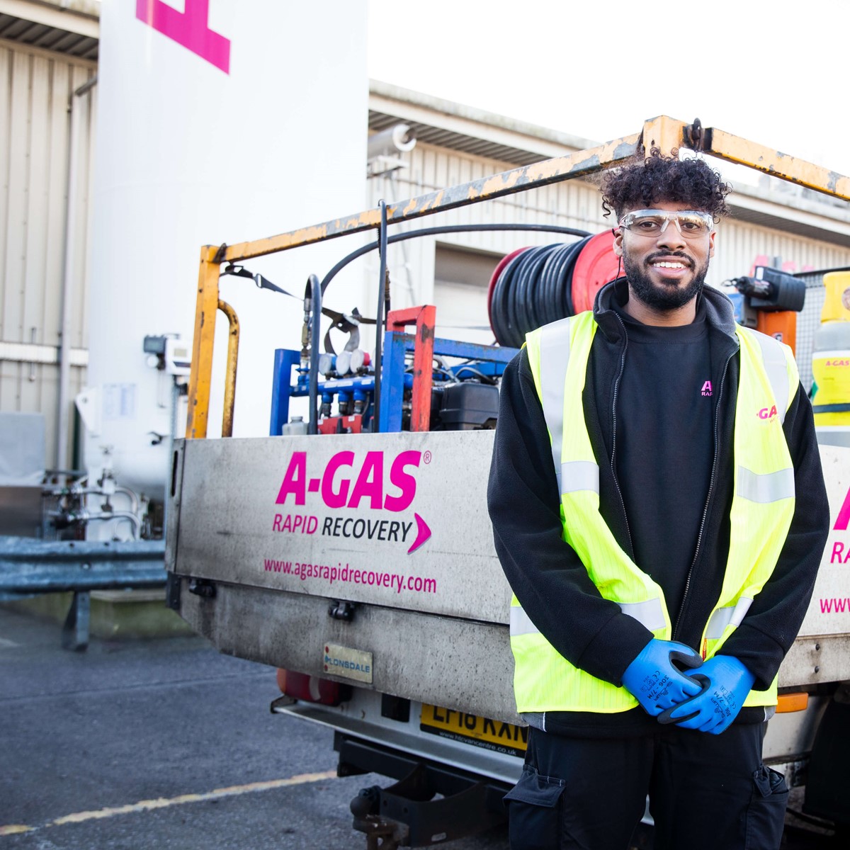 recovery engineer standing in front of service vehicle