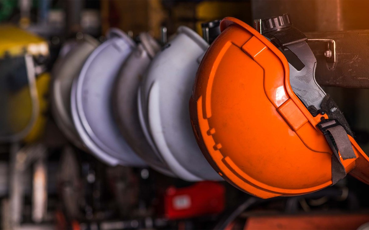 selection of hard hats hung on wall