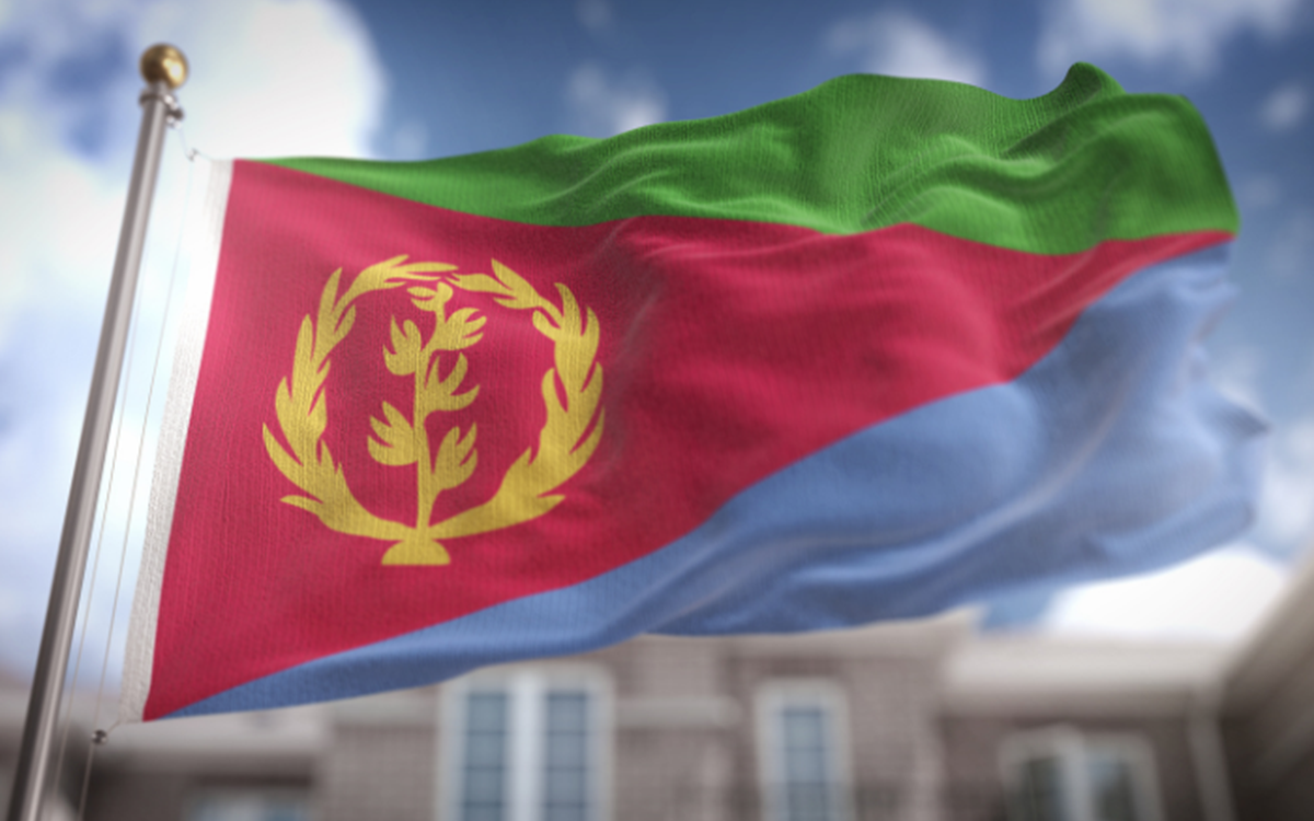 The red, green and blue flag of Eritrea outside against a blurred background