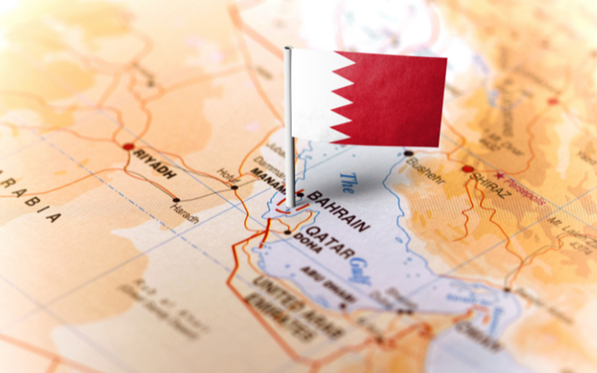 A graphic of the Qatar flag against the backdrop of a world map