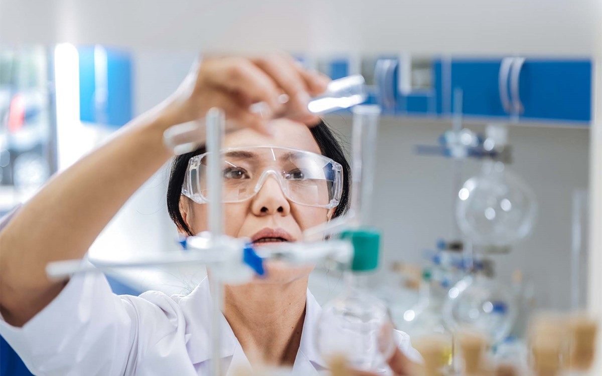 female lab technician measuring liquids