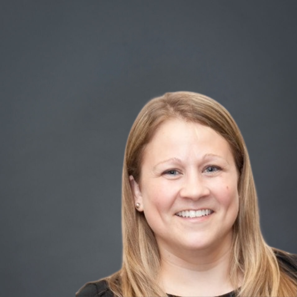 A headshot of a blonde woman smiling against a grey background