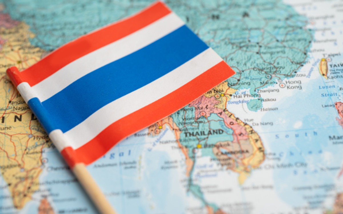 A graphic featuring the Thai flag against the backdrop of a world map