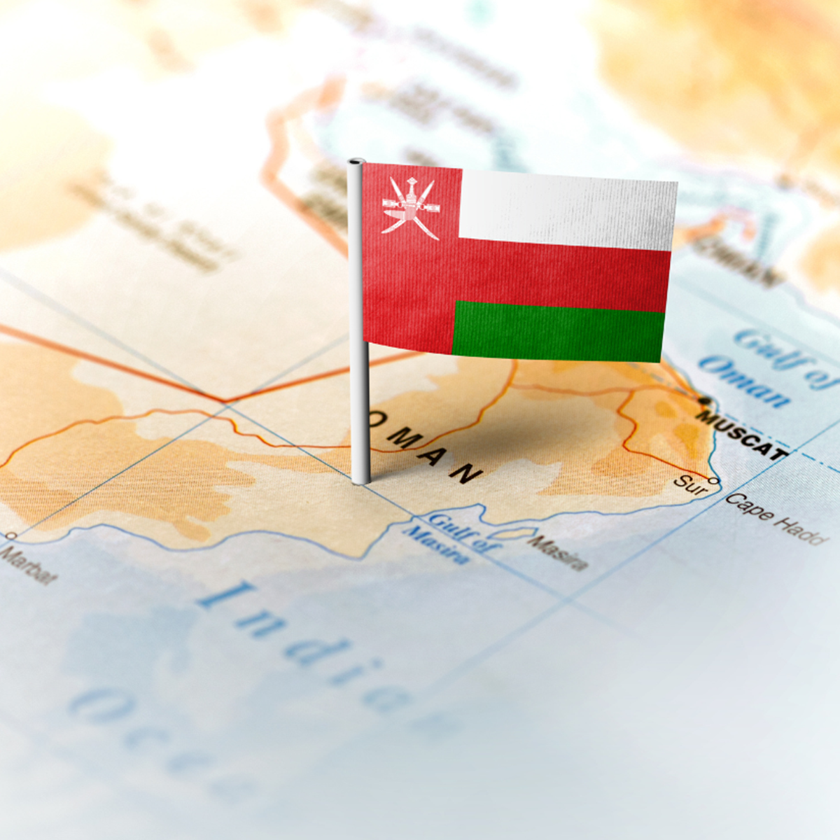 The Oman flag against the backdrop of a world map