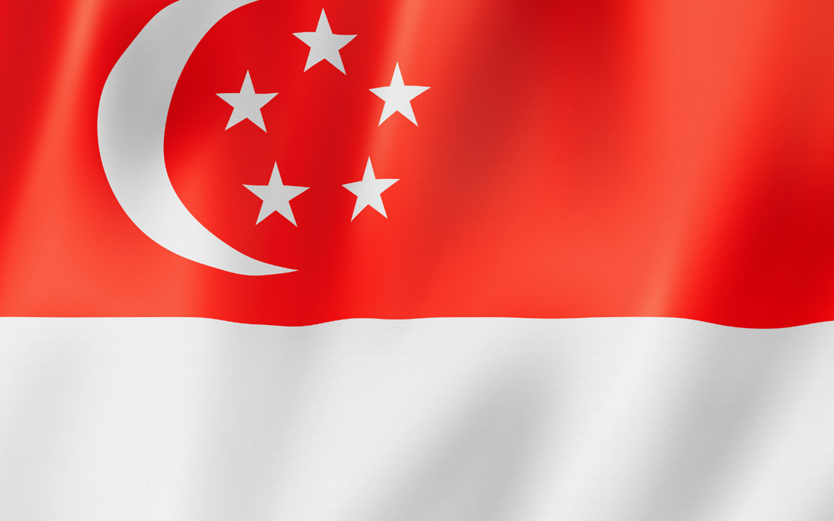 The red and white Singapore flag with a white moon and stars on the top left-hand corner