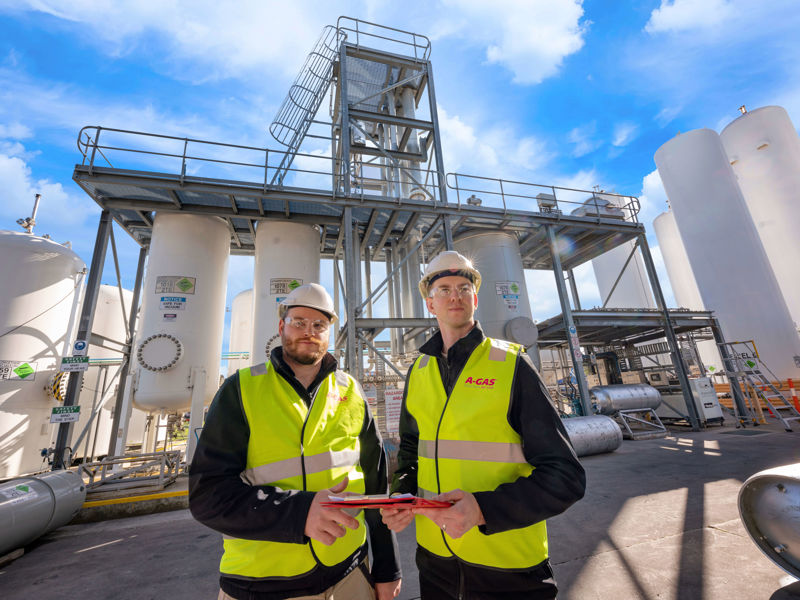 Technicians Standing by Separators
