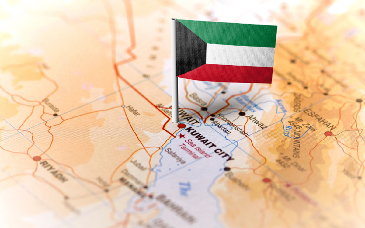 The Kuwait flag against the background of a world map