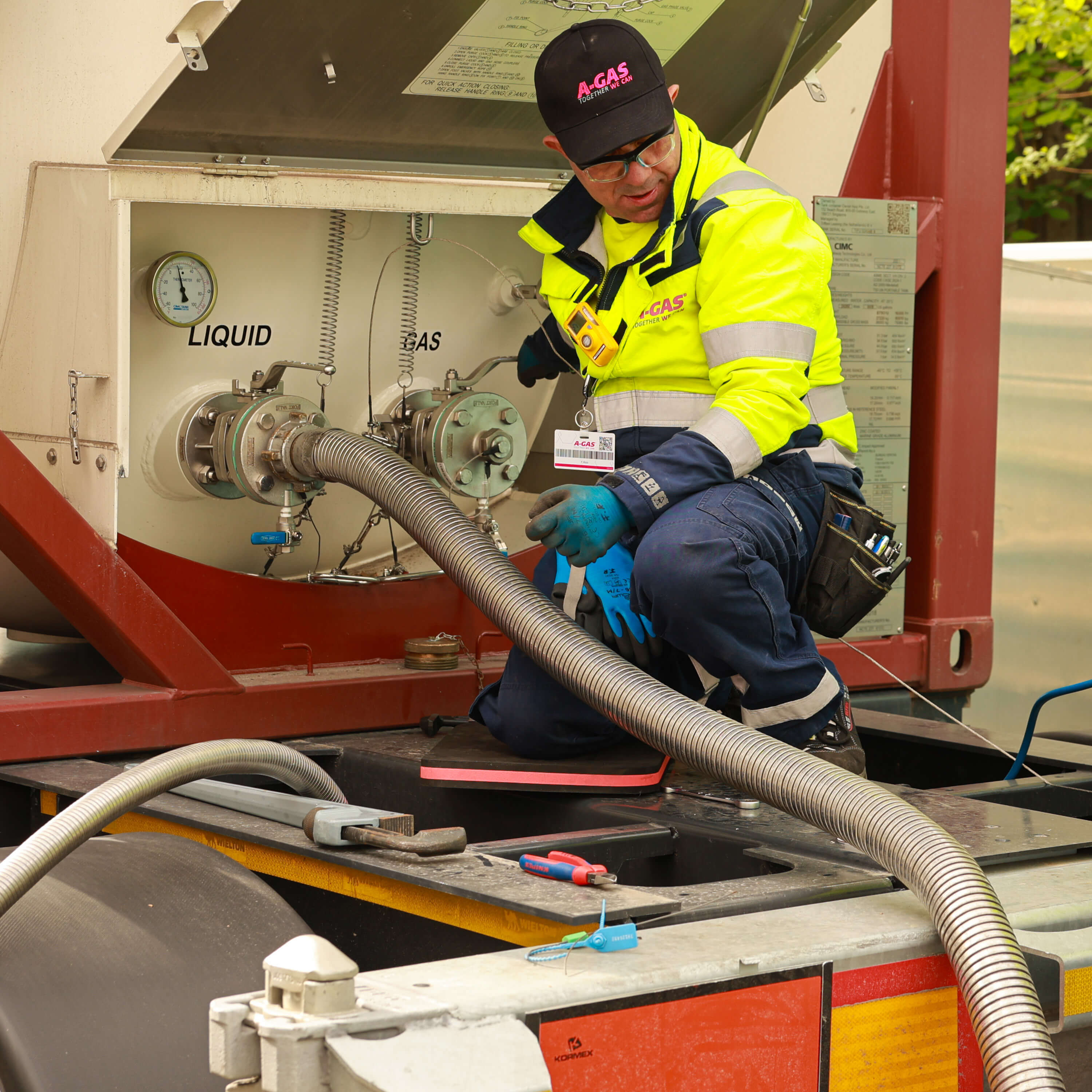 Man in a yellow high-vis jacket working with machinery on-site 