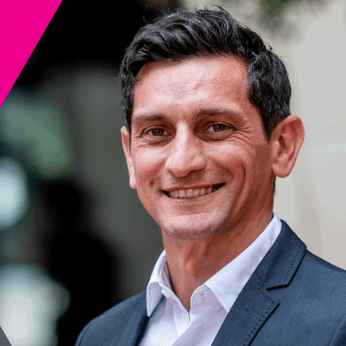 Graphic with photo of man smiling at the camera in hexagon shape