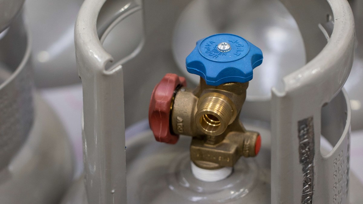 close up of grey cylinder with blue valve head