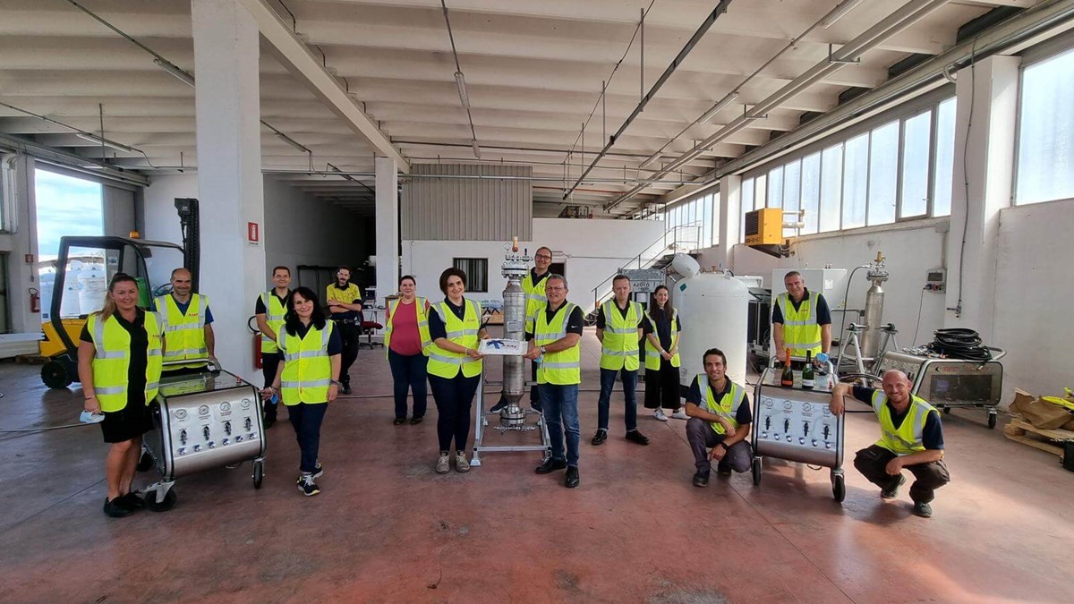 A Group of Gas company workers lined up in hi vis jackets to celebrate the opening of their site