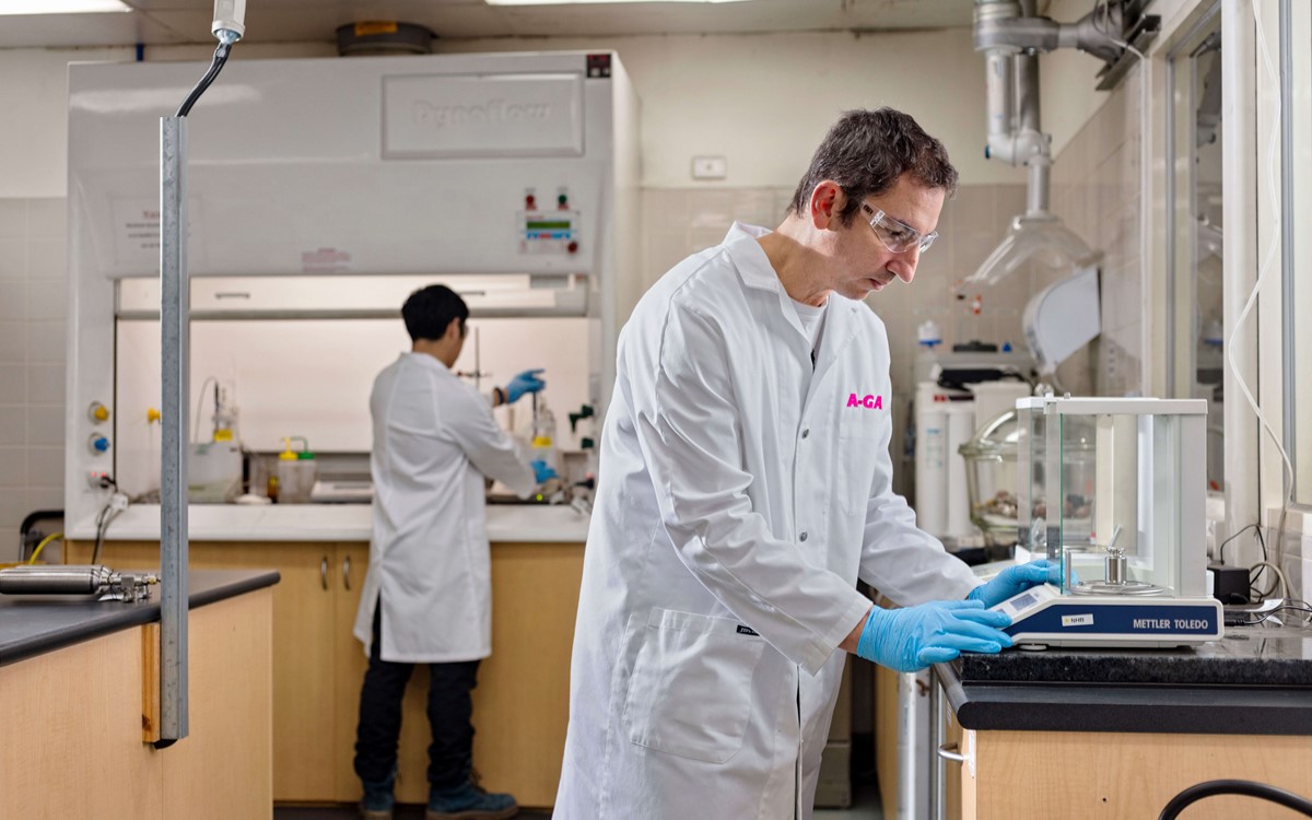 Two men in white coats working in a laboratory
