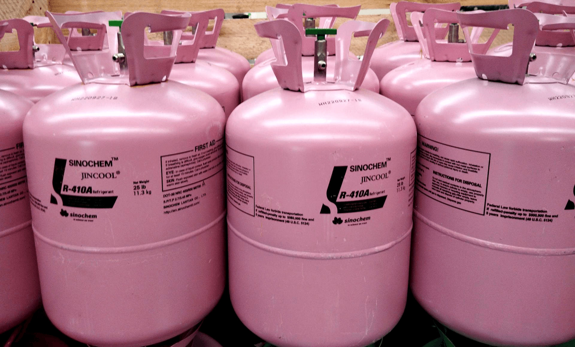 Rows of pink disposable cylinders in a warehouse 