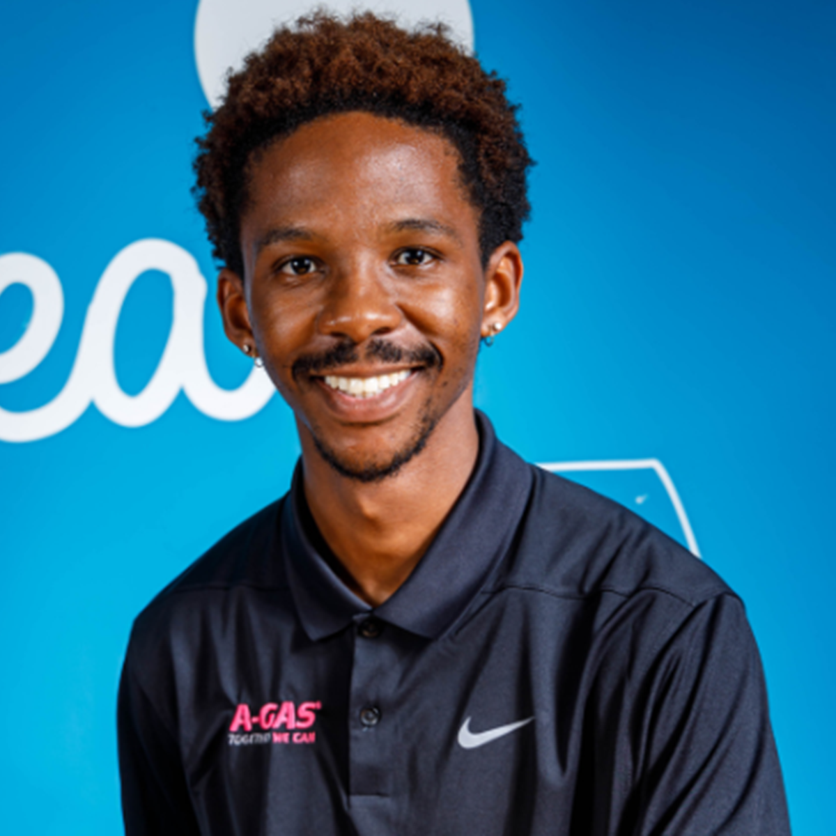 Headshot of a man against a light blue background
