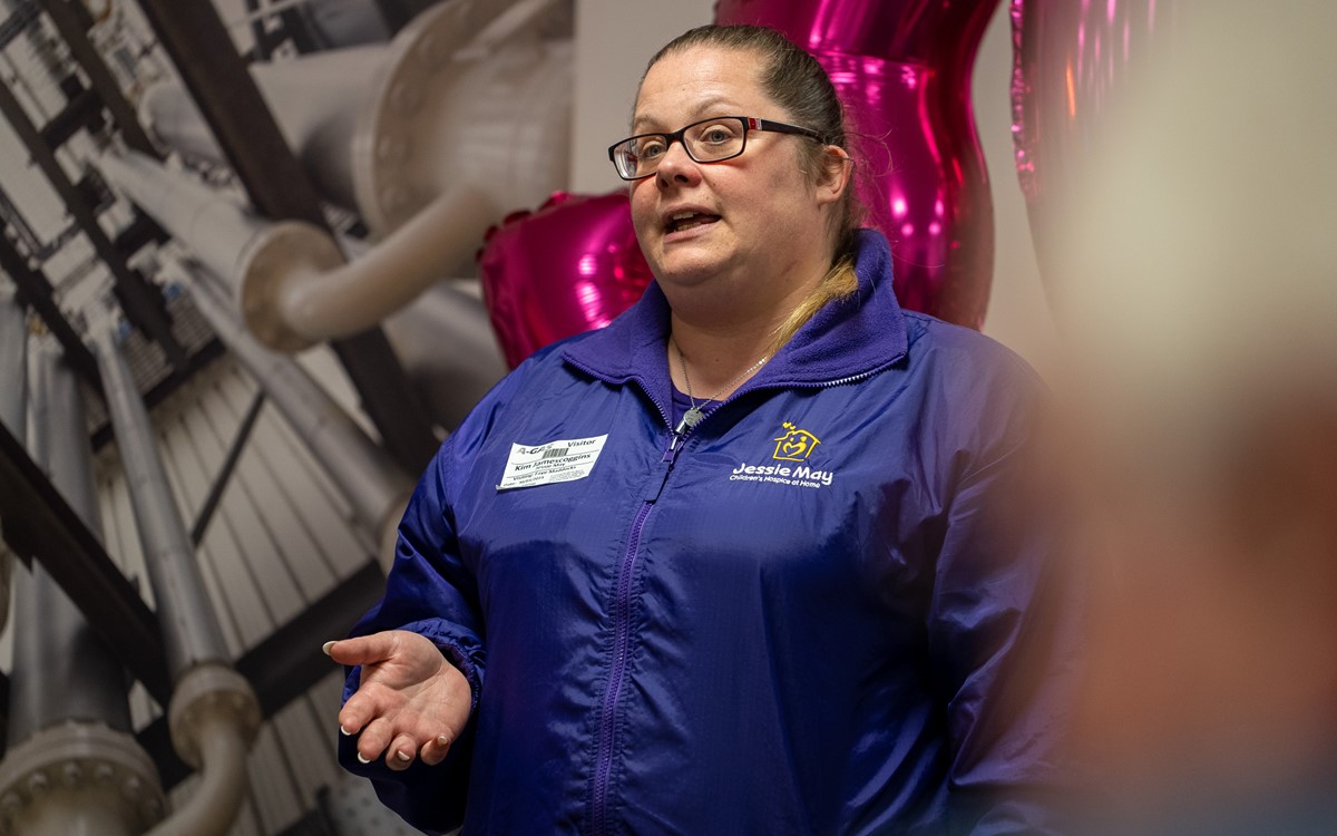 A woman in a purple jacket with the Jessie May charity talking