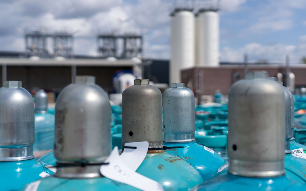 Metal tops on blue cylinders on a site outside