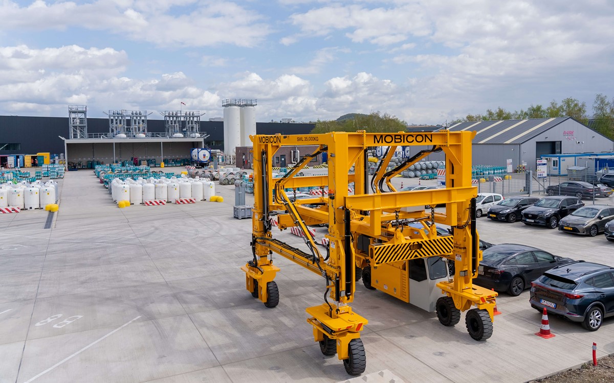 Orange crane structure and cylinders on a site