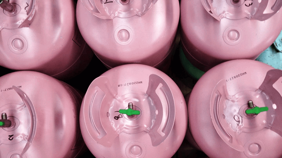 Rows of pink disposable cylinders in a warehouse from above