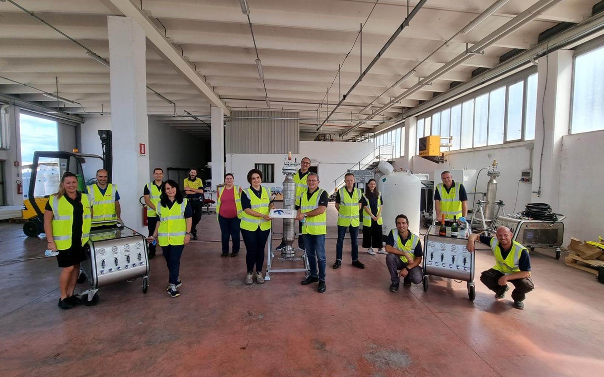 A Group of Gas company workers lined up in hi vis jackets to celebrate the opening of their site