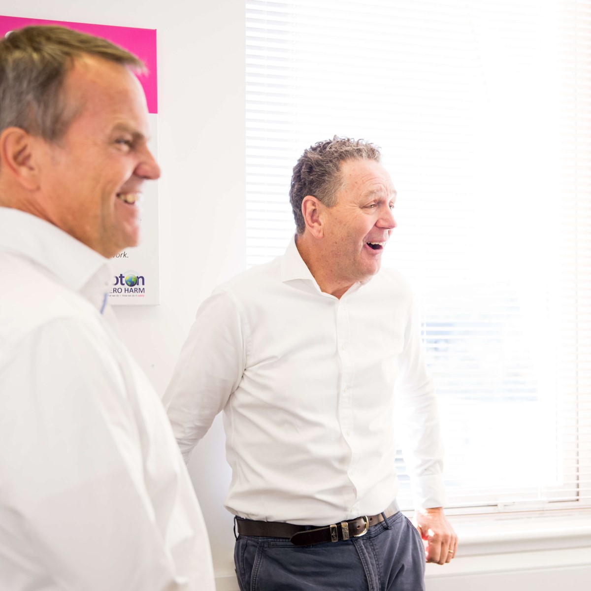 business colleagues sharing a joke in the office